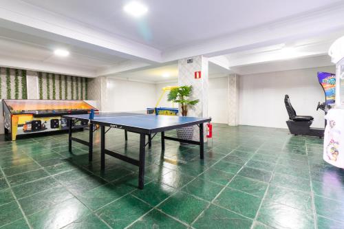 a room with a ping pong table in it at Luz Hotel by Castelo Itaipava in Foz do Iguaçu