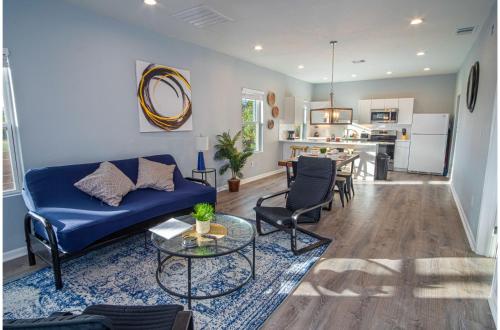 a living room with a blue couch and a table at Downtown Dream Home Spacious 4BR2BA Sleeps 12 in San Antonio