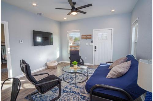 a living room with a blue couch and a table at Downtown Dream Home Spacious 4BR2BA Sleeps 12 in San Antonio