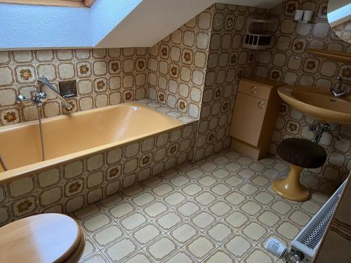 a bathroom with a tub and a sink at Unter den Wolken in Winterberg