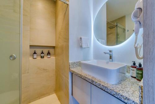 a bathroom with a sink and a mirror at Apt w/2 beds - Private Balcony - Infinity Pool in Puerto Vallarta