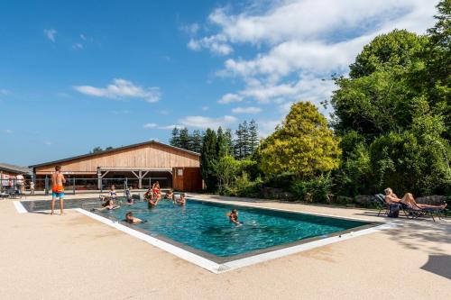 a group of people swimming in a swimming pool at Camping LA SERRE in Aigues-Vives