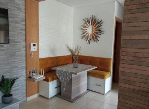 a bathroom with a table and a mirror on the wall at home & room center of rabat in Rabat