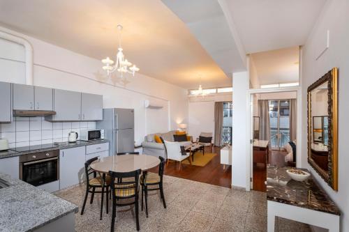 a kitchen and living room with a table and chairs at 1-80 Collection by TrulyCyprus in Limassol