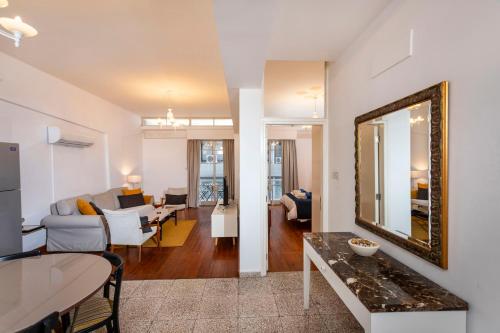 a living room with a mirror and a couch at 1-80 Collection by TrulyCyprus in Limassol