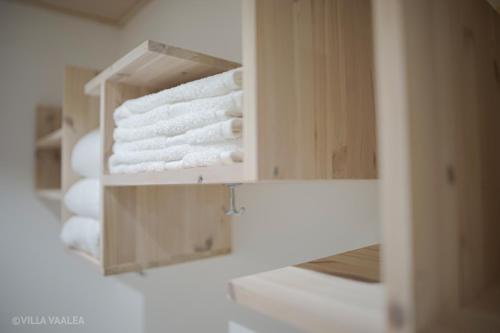 a stack of towels in a cabinet in a bathroom at Villa Vaalea in Rovaniemi