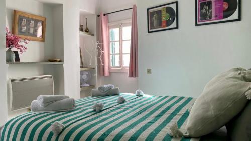 a bedroom with a bed with stuffed animals on it at DAR MOUIMA in Tangier