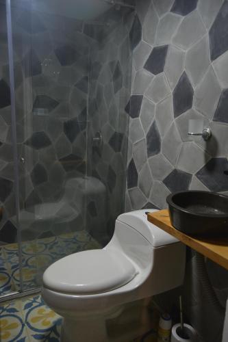 a bathroom with a toilet and a sink at SLH Boutique Guesthouse in Pasto