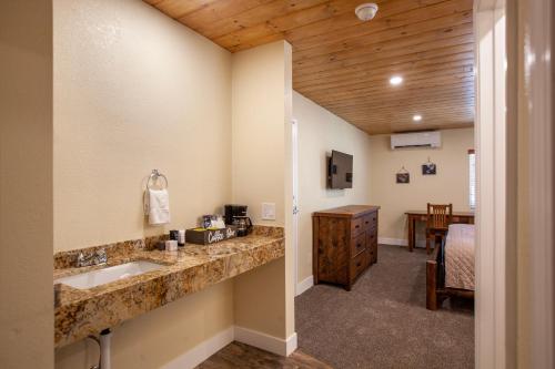 a bathroom with a sink and a room with a table at Tahquitz Pines Retreat in Idyllwild