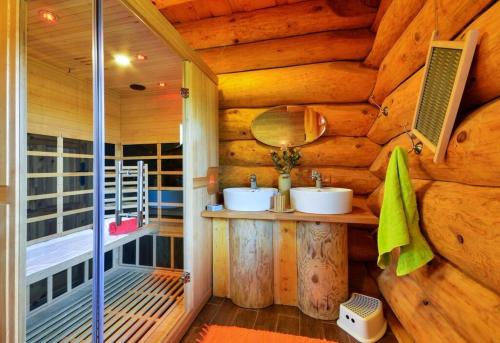 a bathroom with two sinks in a log cabin at Srub Losiny in Velké Losiny