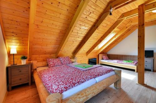 a bedroom with a bed in a wooden cabin at Srub Losiny in Velké Losiny