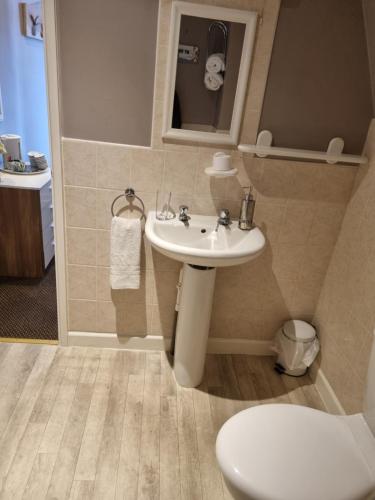 a bathroom with a sink and a toilet at Lexham Hotel in Blackpool