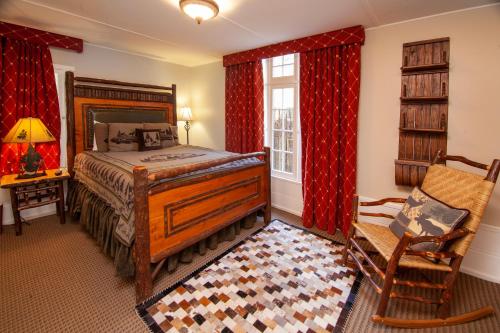 a bedroom with a bed and a chair and a window at Tahquitz Pines Retreat in Idyllwild