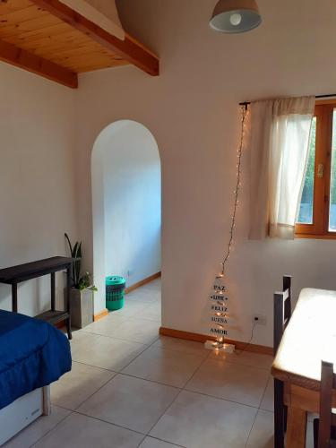 a living room with a bed and a window at La casa de arriba in El Bolsón