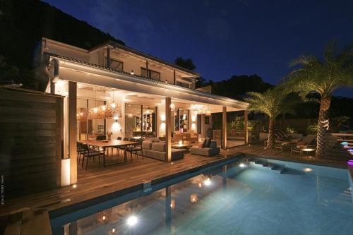 a house with a pool in front of it at night at Villa Nagabaaja in Saint Barthelemy