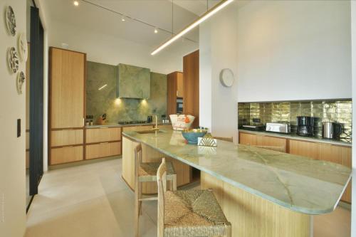 a kitchen with a large island in the middle at Villa Nagabaaja in Saint Barthelemy
