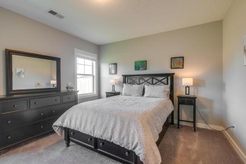a bedroom with a bed and a dresser and a mirror at Lovely Bowling Green Home, 10 Mi to Downtown! in Bowling Green
