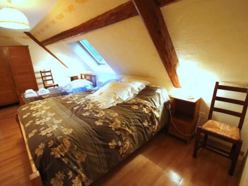 a bedroom with a bed and a table and a chair at Gîte Orbey, 4 pièces, 6 personnes - FR-1-744-26 in Orbey