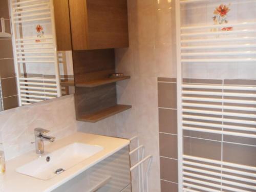 a bathroom with a sink and a mirror at Gîte Orbey, 2 pièces, 2 personnes - FR-1-744-25 in Orbey