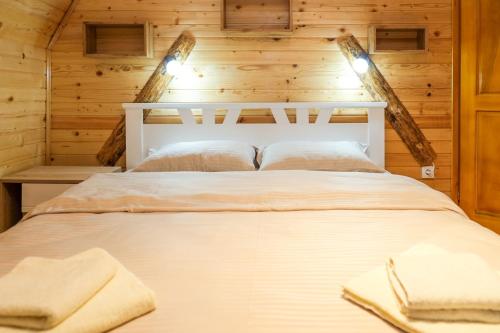 a bedroom with a bed in a log cabin at Villa Zagorka and mountain houses A, M, D in Kopaonik