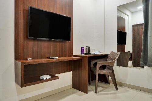 a room with a desk with a television on a wall at hotel Fortune Suites Baner-- Indian nationals only in Pune