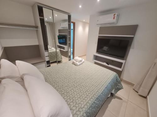 a bedroom with a bed and a flat screen tv at Luxor Paulo Miranda Home Service in João Pessoa