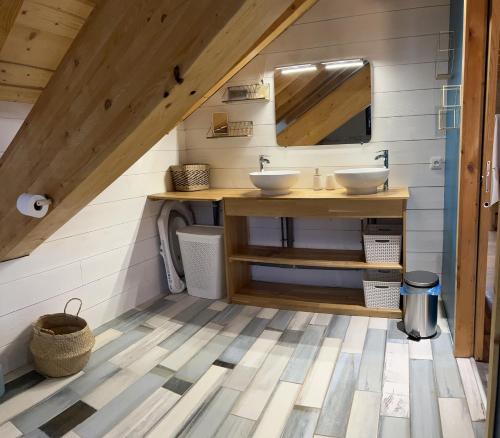 a bathroom with two sinks and a mirror at Chalet La Morte in La Morte