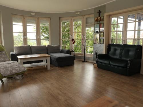 a living room with a couch and a table at Villa Mira in Mačkat