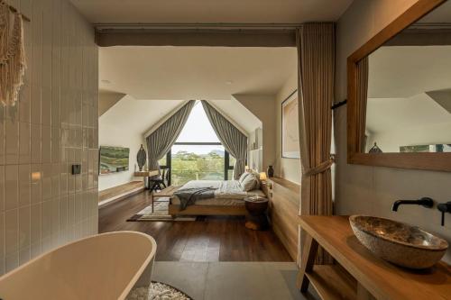 a bathroom with a sink and a bed in a room at LAKE HILL Villas in Bao Loc