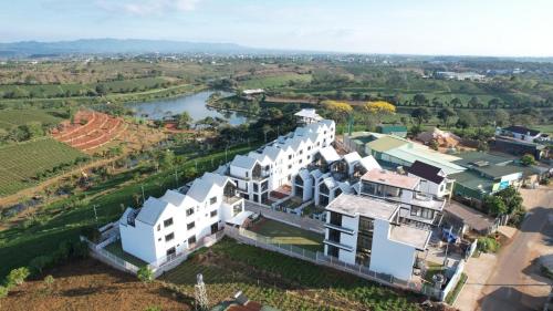 an aerial view of a large white building next to a river at LAKE HILL Villas in Bao Loc