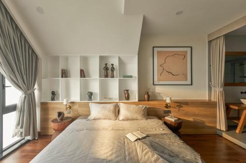 a bedroom with a large bed and a large window at LAKE HILL Villas in Bao Loc
