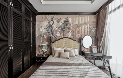 a bedroom with a large bed with a floral wallpaper at LAKE HILL Villas in Bao Loc