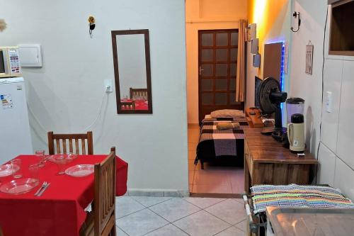um quarto com uma mesa e uma cozinha com um quarto com uma cama em kitnet em São João Del Rei, a 11km de Tiradentes MG em São João del Rei