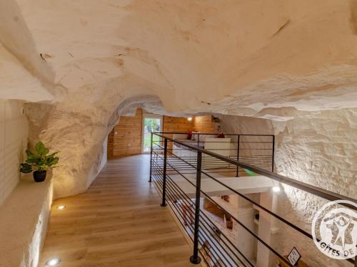 a house made out of a cave with a staircase at Gîte troglodyte unique avec jacuzzi, billard et jardin, près de Doué La Fontaine et Saumur - FR-1-622-69 in Les Ulmes