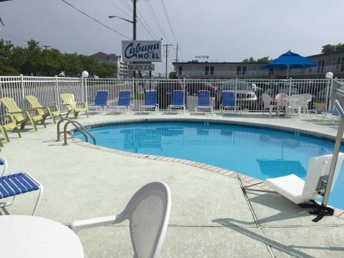 una piscina con sillas y raqueta de tenis en Cabana Motel, en Ocean City