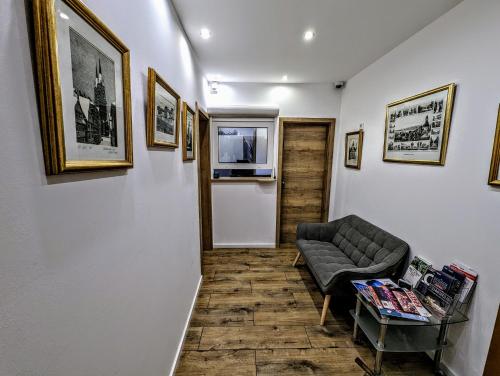 a living room with a couch and pictures on the wall at Hotel am Rathaus in Kassel