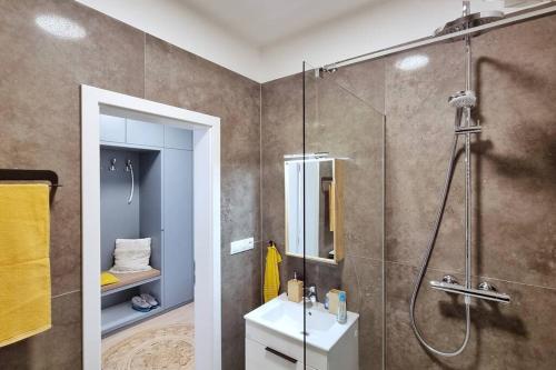 a bathroom with a shower and a sink at 10 Minutes to City: Cozy Urban Apartment Stay in Bratislava
