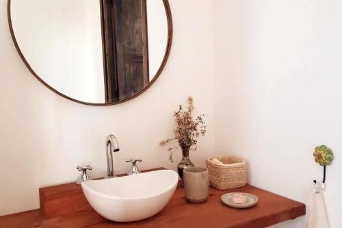 a bathroom with a white sink and a mirror at Estancia La Josefina in Villa Tulumba