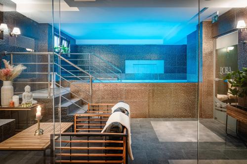 a bathroom with a shower with blue lighting at Boutique Hotel Bora & Villas Garamm in Pakoštane