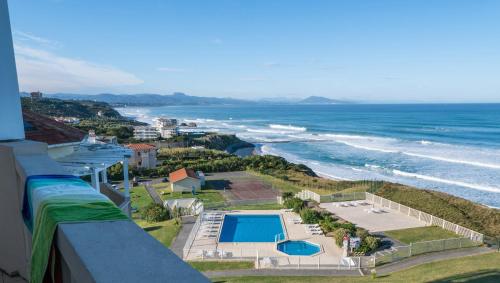 a view of the ocean from the balcony of a building at Résidence Mer & Golf Eugénie in Biarritz