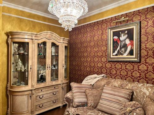 a living room with a couch and a chandelier at Luxury Flat close to the Border in Narva