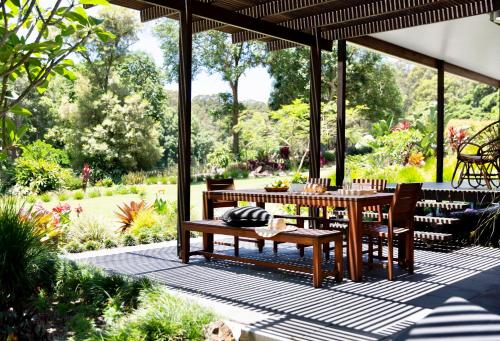 a patio with a table and chairs under a pavilion at Lily Pad at Byron Bay in Byron Bay