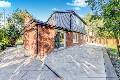 a brick house with a large patio at Stunning 7 Br RougeView Home with 2 Kitchens, 5 Bathrooms, Amazing Backyard & 8-Car Parking in Toronto