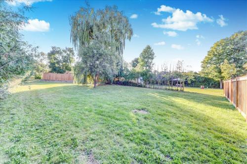 a large yard with a willow tree in the middle at Stunning 7 Br RougeView Home with 2 Kitchens, 5 Bathrooms, Amazing Backyard & 8-Car Parking in Toronto