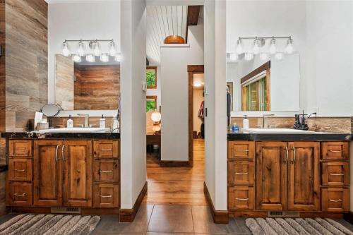 a kitchen with wooden cabinets and a large sink at Sugarloaf Summit Rare Tamarack Ski Inout Estate in Donnelly