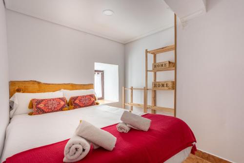 a bedroom with a bed with two towels on it at Elantxobe Centre in Elanchove