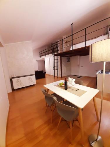 a living room with a table and a loft at Sapori e Sapere di Troisi Margherita in Sicignano degli Alburni