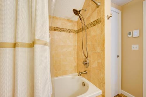 a bathroom with a shower and a white tub at Sunny Stratton Townhome about 1 Mi to Skiing! in Stratton