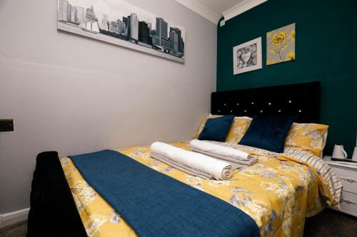 a bedroom with a bed with towels on it at Harmony Haven - Harmony Suite in Nottingham