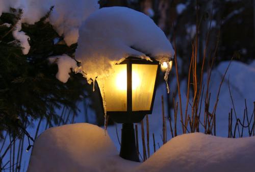 a street light covered in snow next to some grass at L'Auberge du Choucas in Le Monêtier-les-Bains